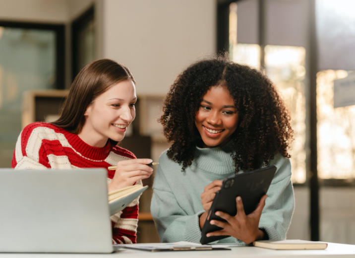 Two business partners using a tablet to work on their marketing strategy.