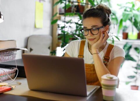 Young woman using a laptop in her home office