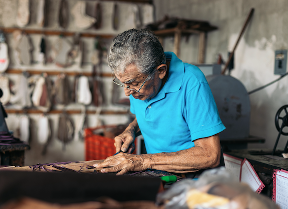Shoemaker working in his mom and pop shop