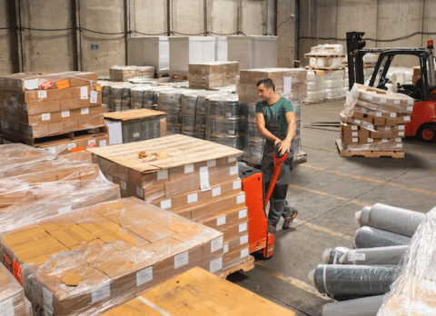 Warehouse worker moving imported goods