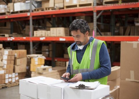 Warehouse worker inventorying imported goods