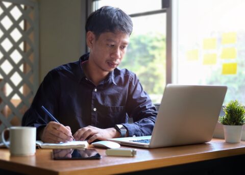 A businessman creating a balance sheet