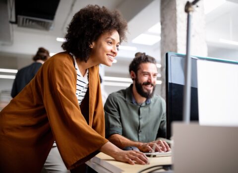 Two accountants sending payments online.