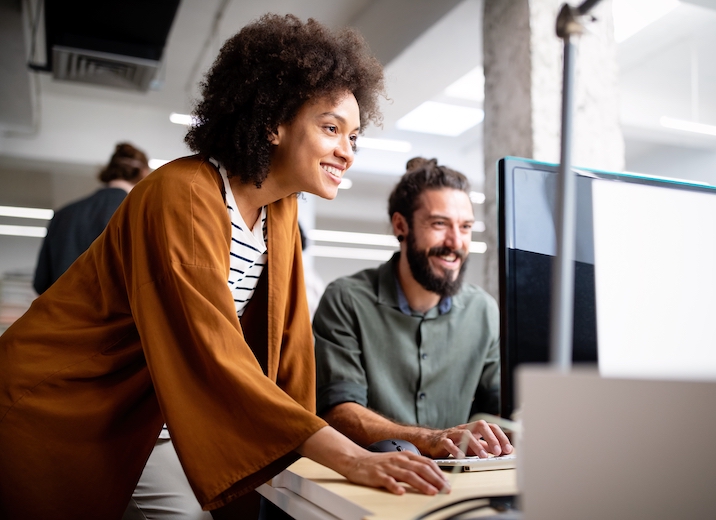 Two accountants sending payments online.