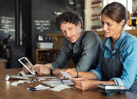 Two restaurant owners preparing their financial statements.
