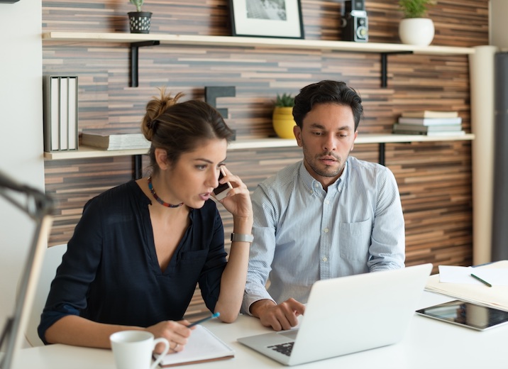 Two accountants using technological tools to help clients.