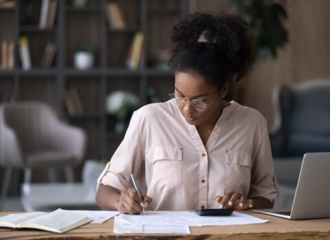 A small business owner preparing a budget to better manage cash flow.