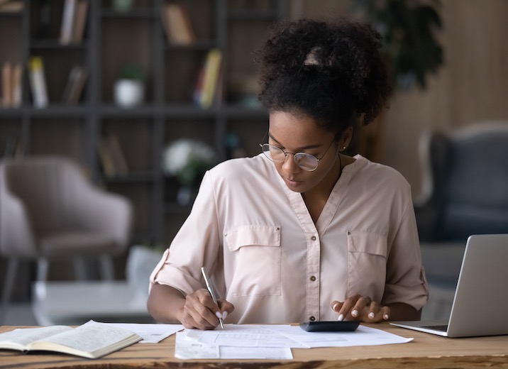 A small business owner preparing a budget to better manage cash flow.