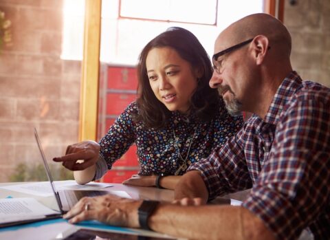 Two business partners managing their payments online.