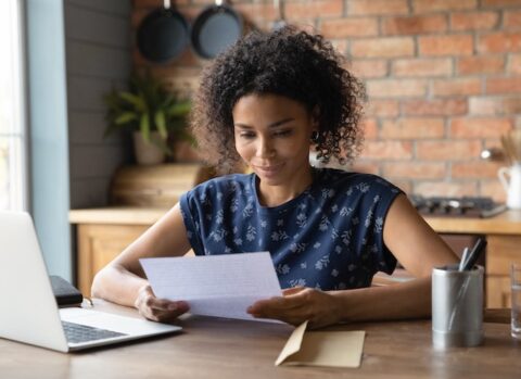 Young small business owner handling an invoice.