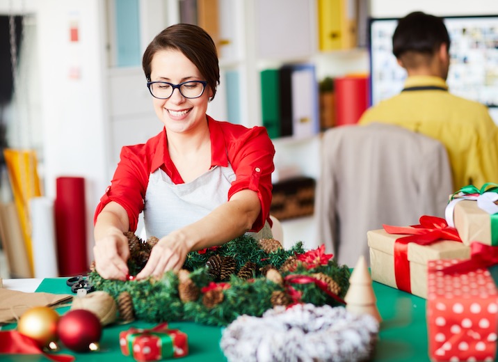 A small business owner setting up holiday decorations.