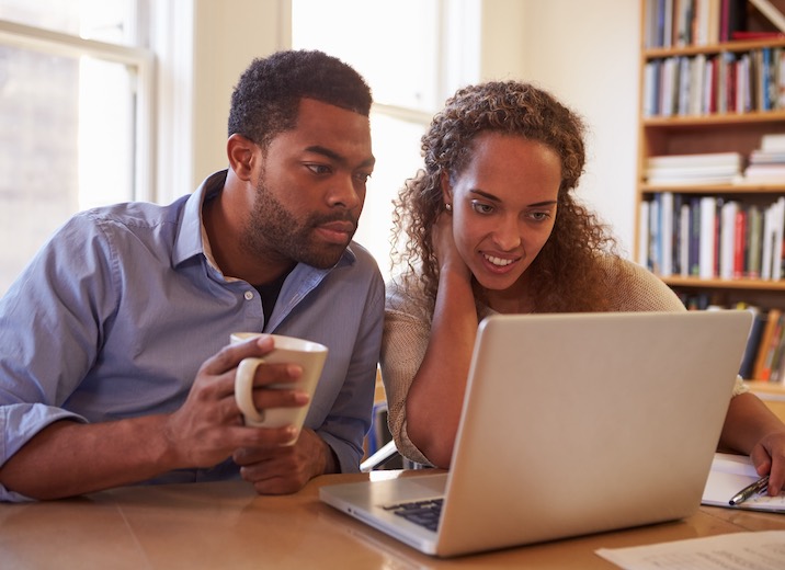 A young couple managing the finances for their small business.