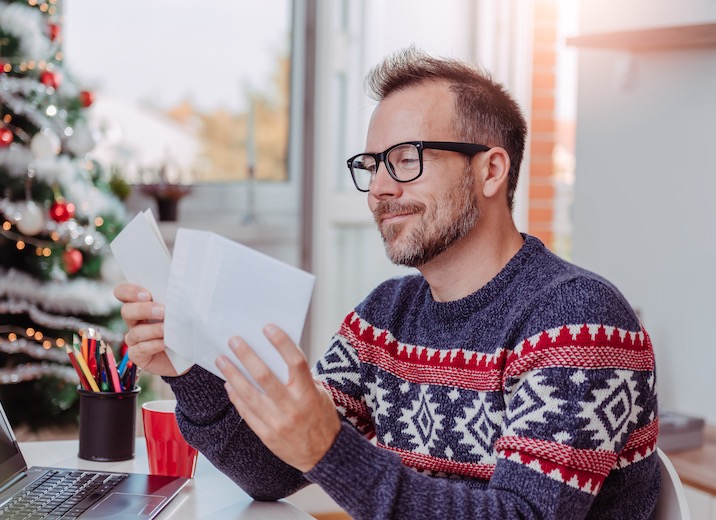 A small business owner going over the mail during the holiday season.