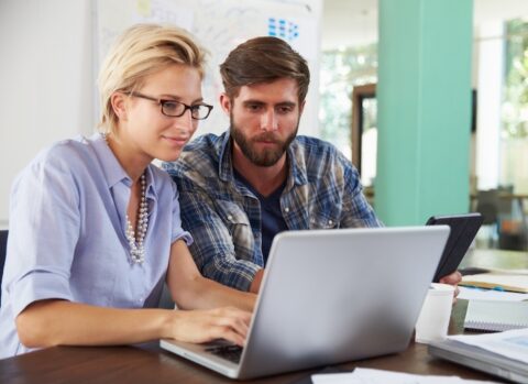 A couple making B2B payments online for their small business.