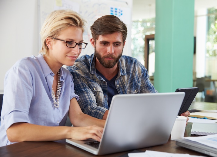 A couple making B2B payments online for their small business.