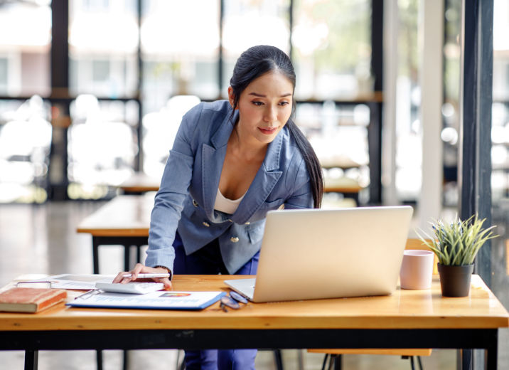 A small business owner preparing for an AP audit by reviewing her books on a laptop.