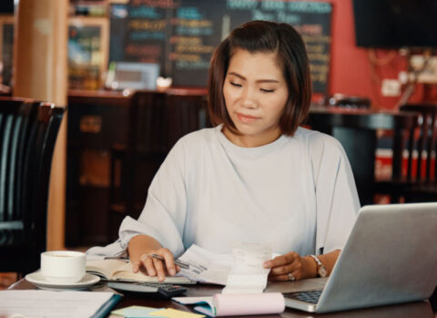 Coffeeshop owner managing the books using accounting software.