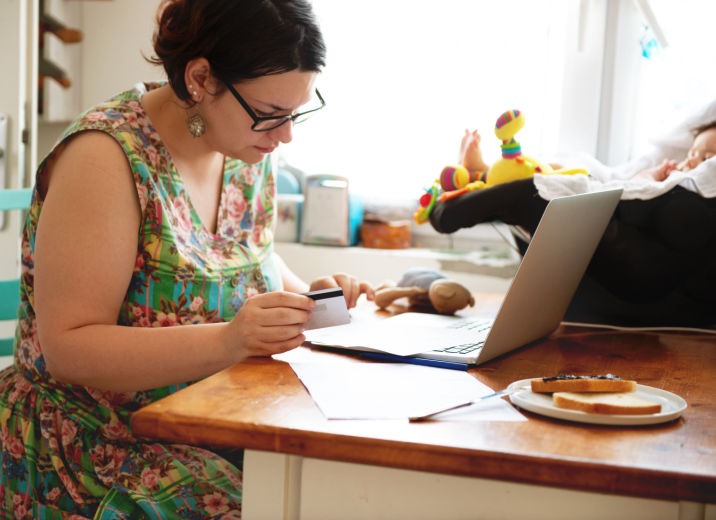A small business owner using accounts payable software to pay her business bills with a credit card online.