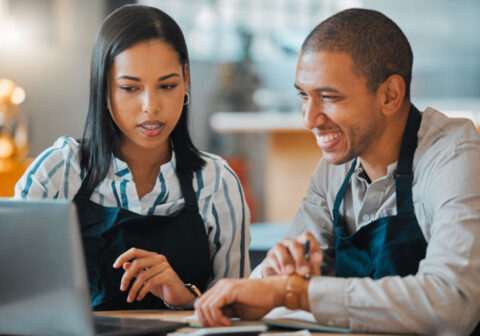 The owners of a coffee shop creating a financial plan for their business.