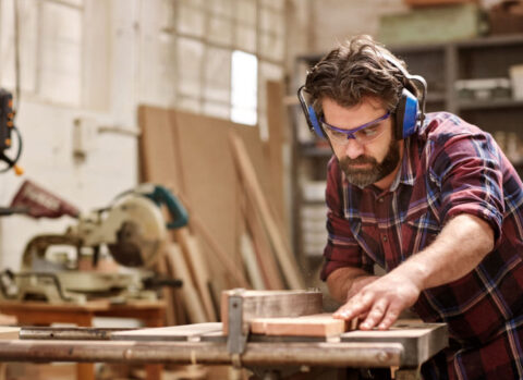 A small business owner working in his woodshop.
