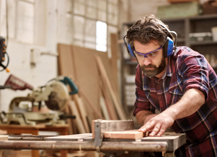 A small business owner working in his woodshop.