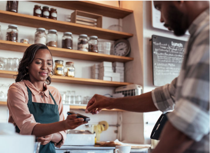 A customer paying with a credit card at a small retailer.