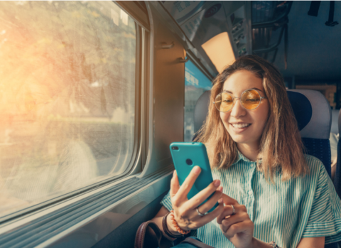 A small business owner gets work done on her phone during the daily commute.
