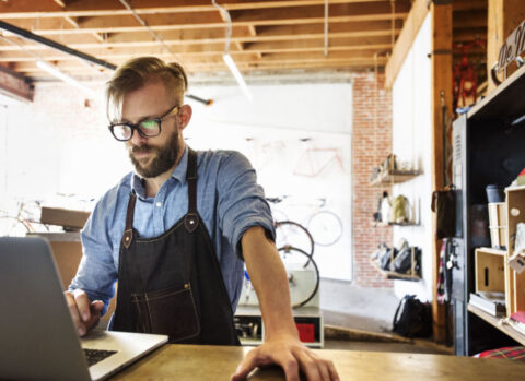A bicycle shop owner managing AP online.