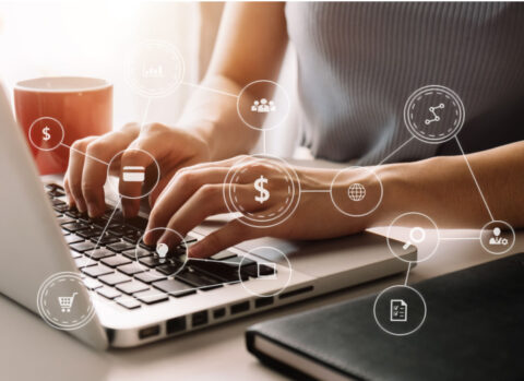 A woman’s hands using a laptop to send digital payments with an illustration of a digital payment network.
