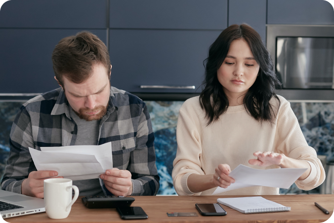 Two business owners paying their utility bills.