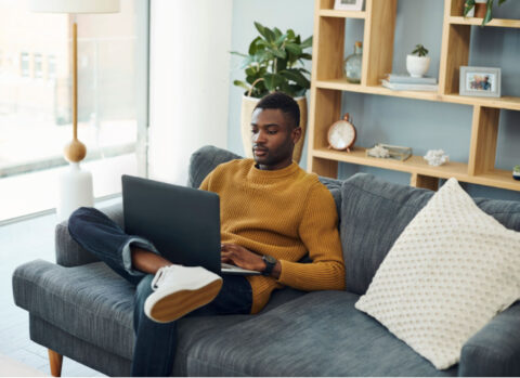 A small business owner working from home uses a laptop to manage accounts receivable online.