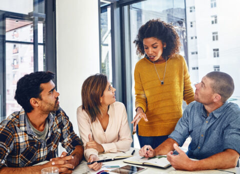 A small business team working together on a project in a well-lit office.