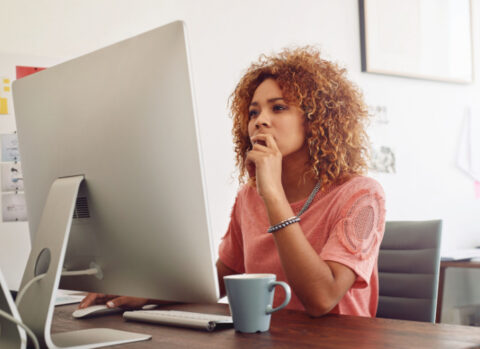 A small business owner using a computer to send an ACH payment to a vendor.