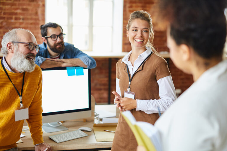 Accountants in a modern office collaborating on financial strategy, with one team member leading the discussion and others actively engaged.